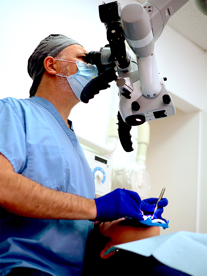 Montreal Dentist - Dr Pierre Pizem on a dental operating microscope